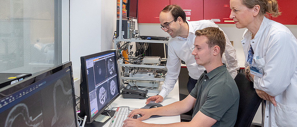 A team led by Prof. Dimitrios Karampinos analyzing MRI images. Prof. Dimitrios Karampinos (back), Jonathan Stelter, PD Dr. Eva Maria Fallenberg. Image: Andreas Heddergott / TUM