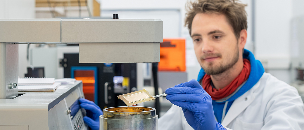 Lukas Hiendlmeier, der ihm Rahmen seiner Doktorarbeit an dem Projekt forscht, beim Bearbeiten der sich selbstfaltenden Elektroden.