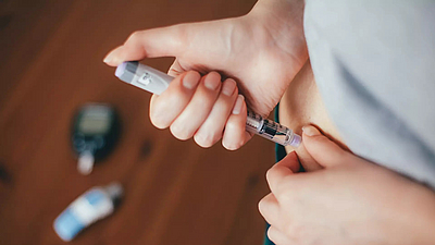A woman injecting insulin