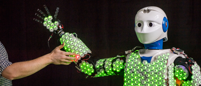 Humanoid robot covered with artificial skin encounters a human.